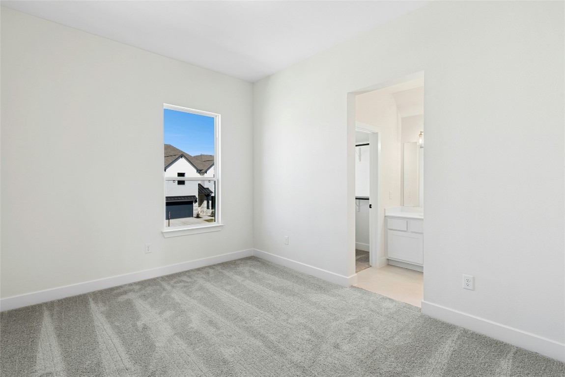 1533 Rodeo Ridge Drive Georgetown, TX 78628 - Photo 21 of 34 Spare room with light colored carpet and baseboards
