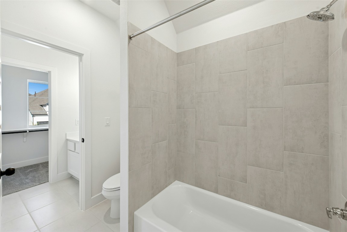 1533 Rodeo Ridge Drive Georgetown, TX 78628 - Photo 23 of 34 Bathroom with bathing tub / shower combination and light tile patterned floors