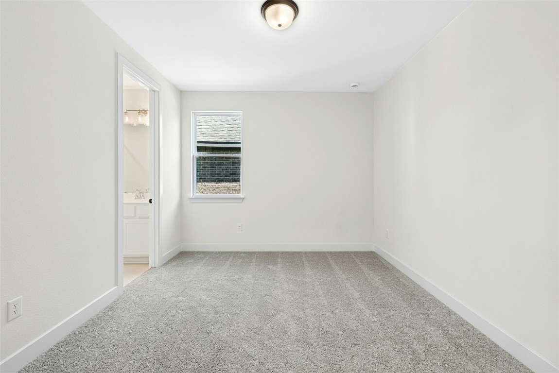 1533 Rodeo Ridge Drive Georgetown, TX 78628 - Photo 24 of 34 Unfurnished bedroom featuring light colored carpet and ensuite bathroom