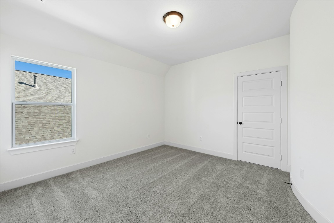 1533 Rodeo Ridge Drive Georgetown, TX 78628 - Photo 26 of 34 Spare room featuring light colored carpet and baseboards