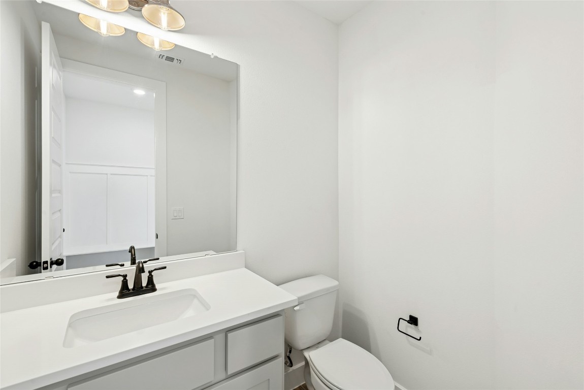 1533 Rodeo Ridge Drive Georgetown, TX 78628 - Photo 10 of 34 Half bath featuring vanity and toilet