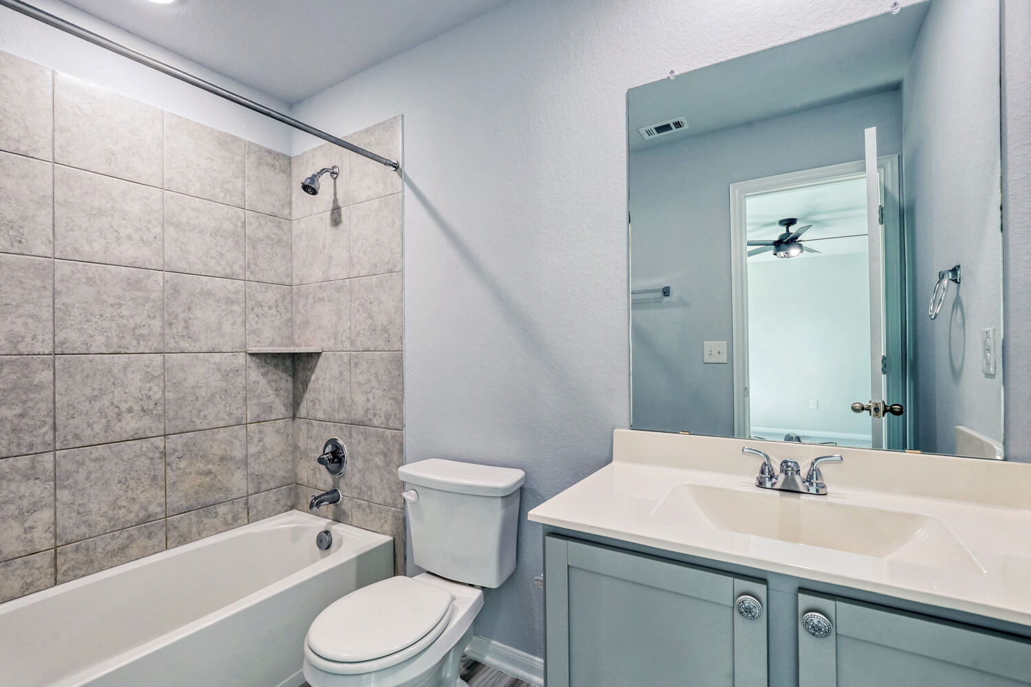 6601 Avila Way Pflugerville, TX 78660 - Photo 22 of 28 Full bathroom featuring vanity, shower / bath combination, and a textured wall