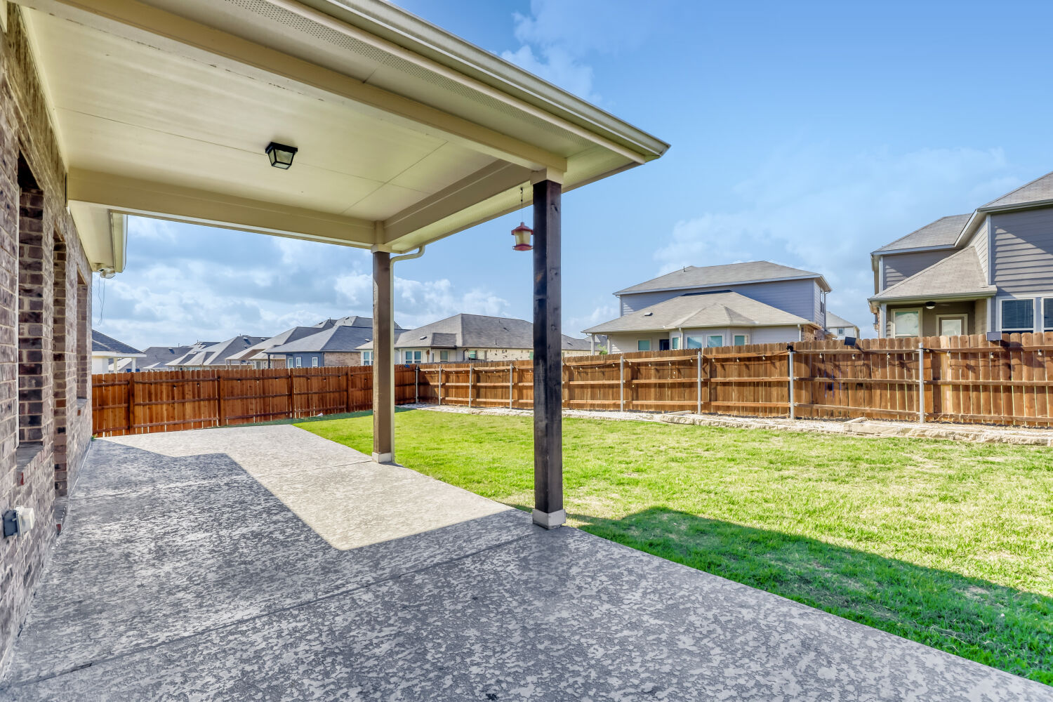 6601 Avila Way Pflugerville, TX 78660 - Photo 25 of 28 Fenced backyard featuring a residential view and a patio