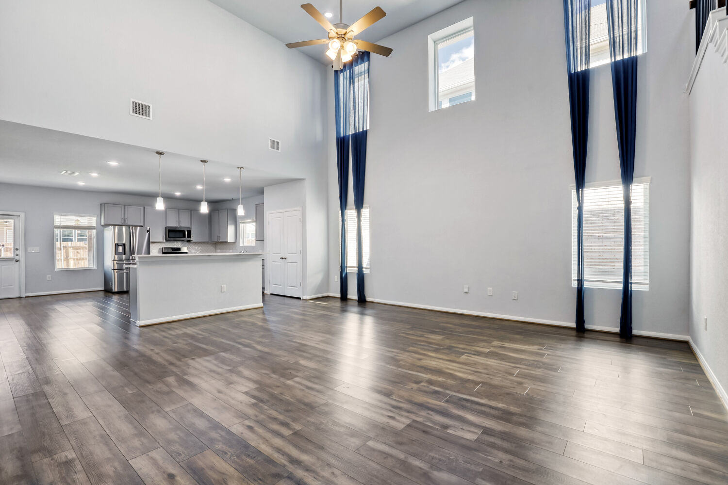 6601 Avila Way Pflugerville, TX 78660 - Photo 4 of 28 Unfurnished living room featuring a ceiling fan, dark wood-type flooring, and recessed lighting