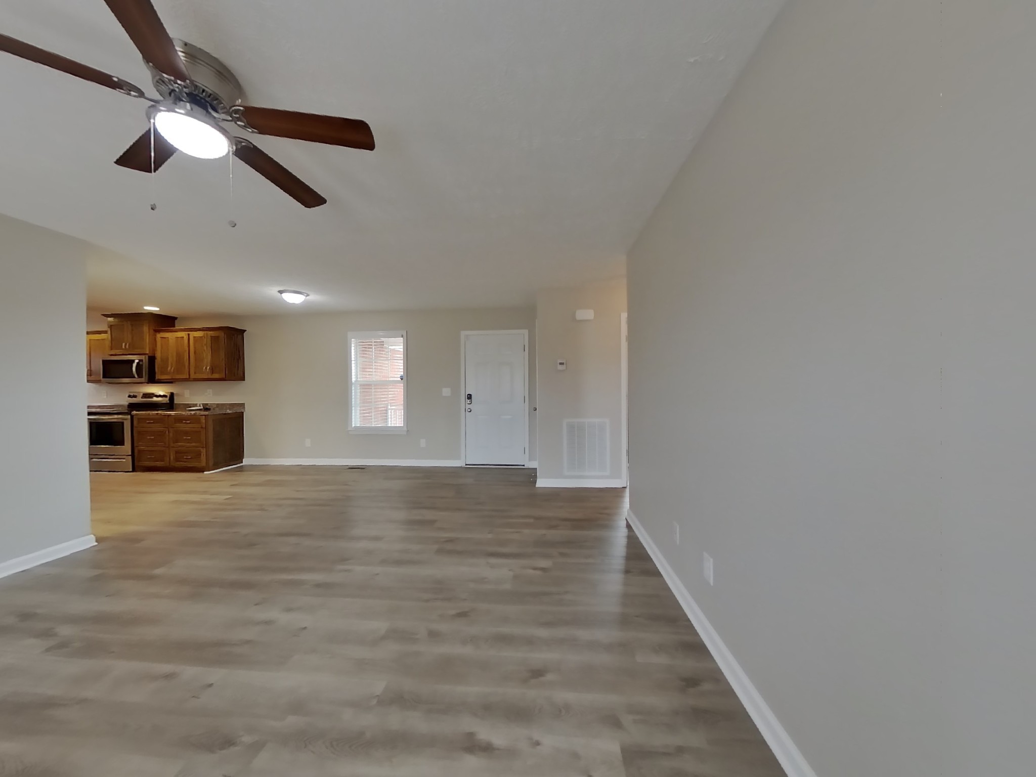 1908 Susan Road Columbia, TN 38401 - Photo 2 of 15 a view of an empty room with wooden floor and a ceiling fan