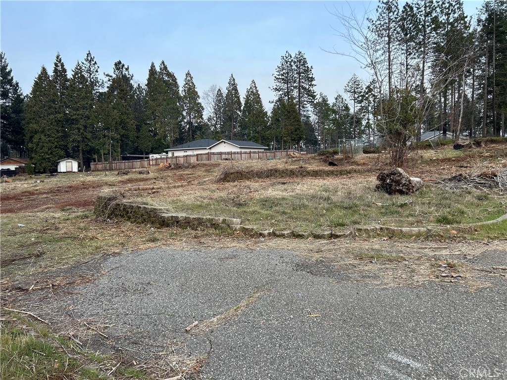 6411 Cumberland Road Magalia, CA 95954 - Photo 2 of 3 a view of dirt field with trees in the background