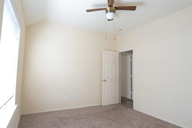 a view of a livingroom with a ceiling fan and window