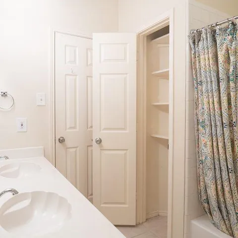 a bathroom with a tub sink and mirror