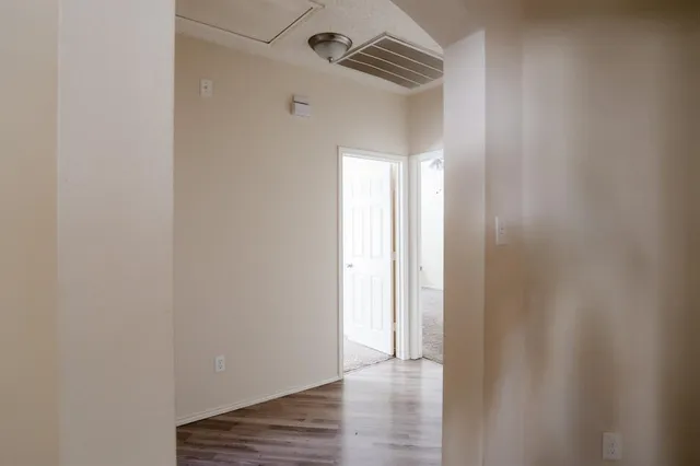 a view of a room with wooden floor and chandelier