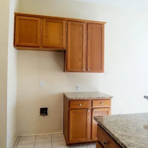 a kitchen with wooden cabinets and a sink