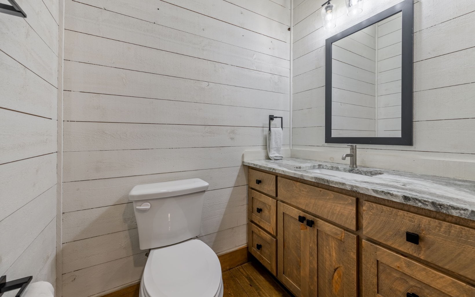 259 Mountain Laurel Lane Blue Ridge, GA 30513 - Photo 31 of 60 a bathroom with a toilet sink and mirror