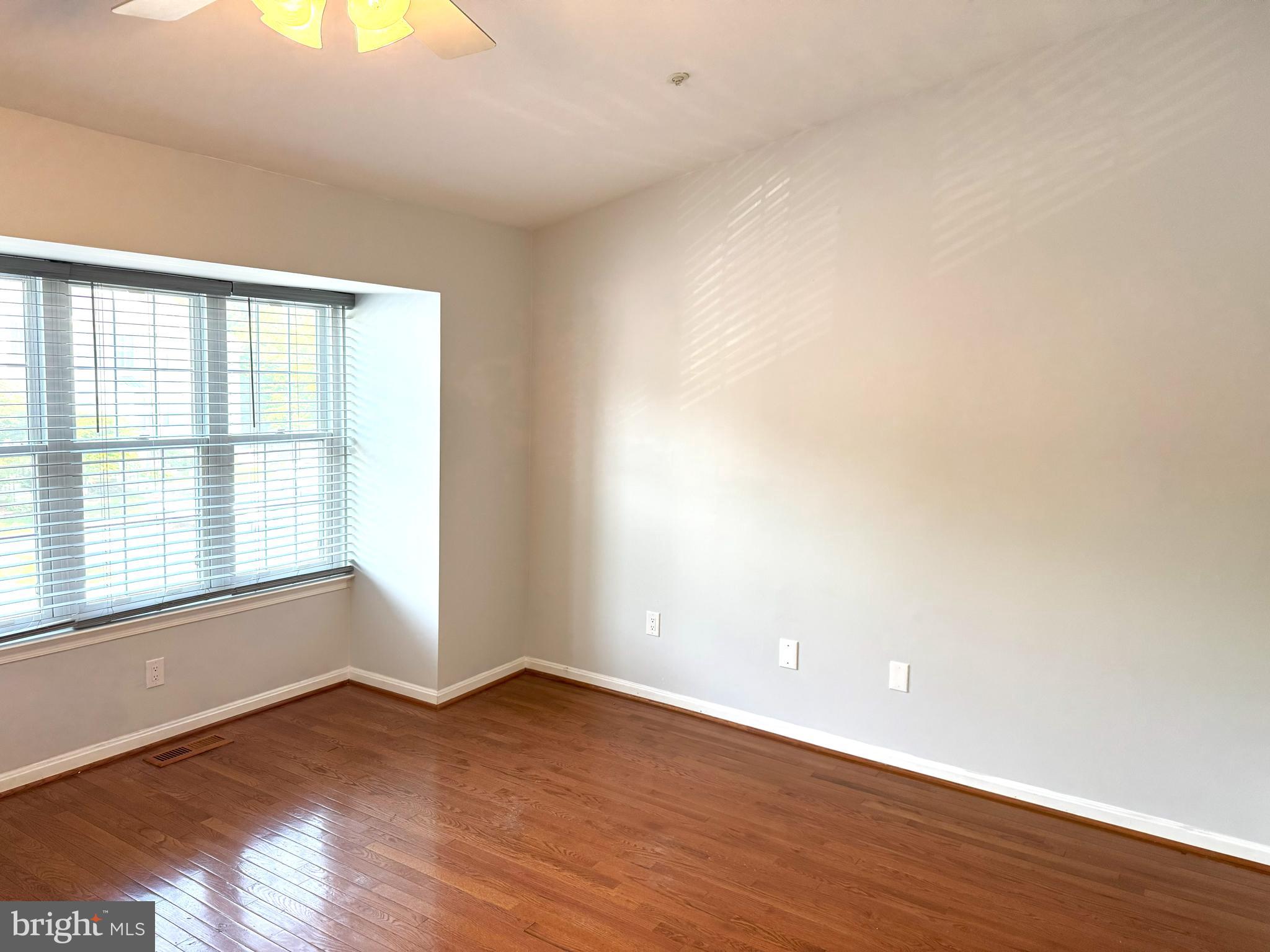 618 Evening Star Place Bowie, MD 20721 - Photo 22 of 59 a view of an empty room with wooden floor and a window