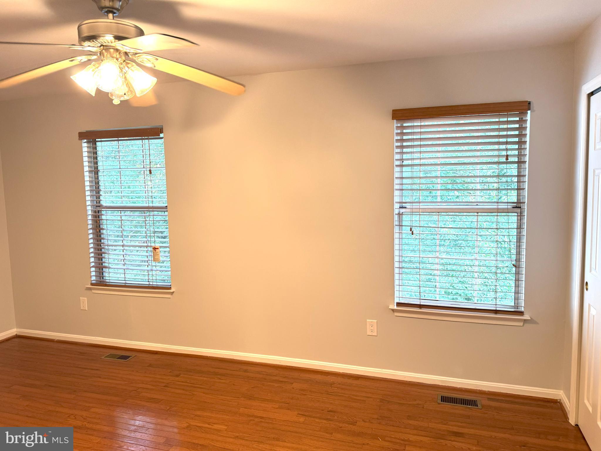 618 Evening Star Place Bowie, MD 20721 - Photo 30 of 59 a view of an empty room with wooden floor and a window