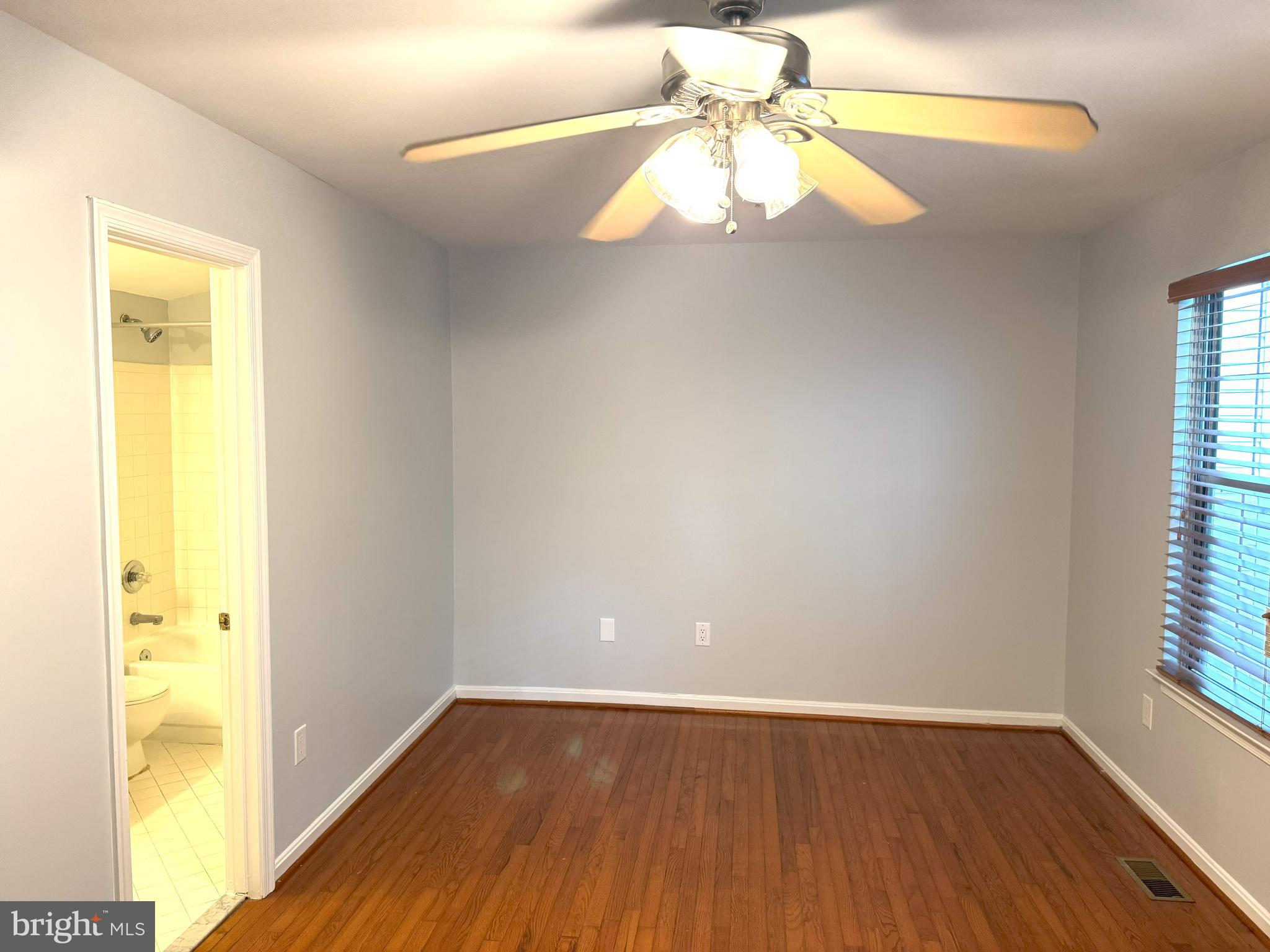 618 Evening Star Place Bowie, MD 20721 - Photo 33 of 59 a view of an empty room with wooden floor and a window