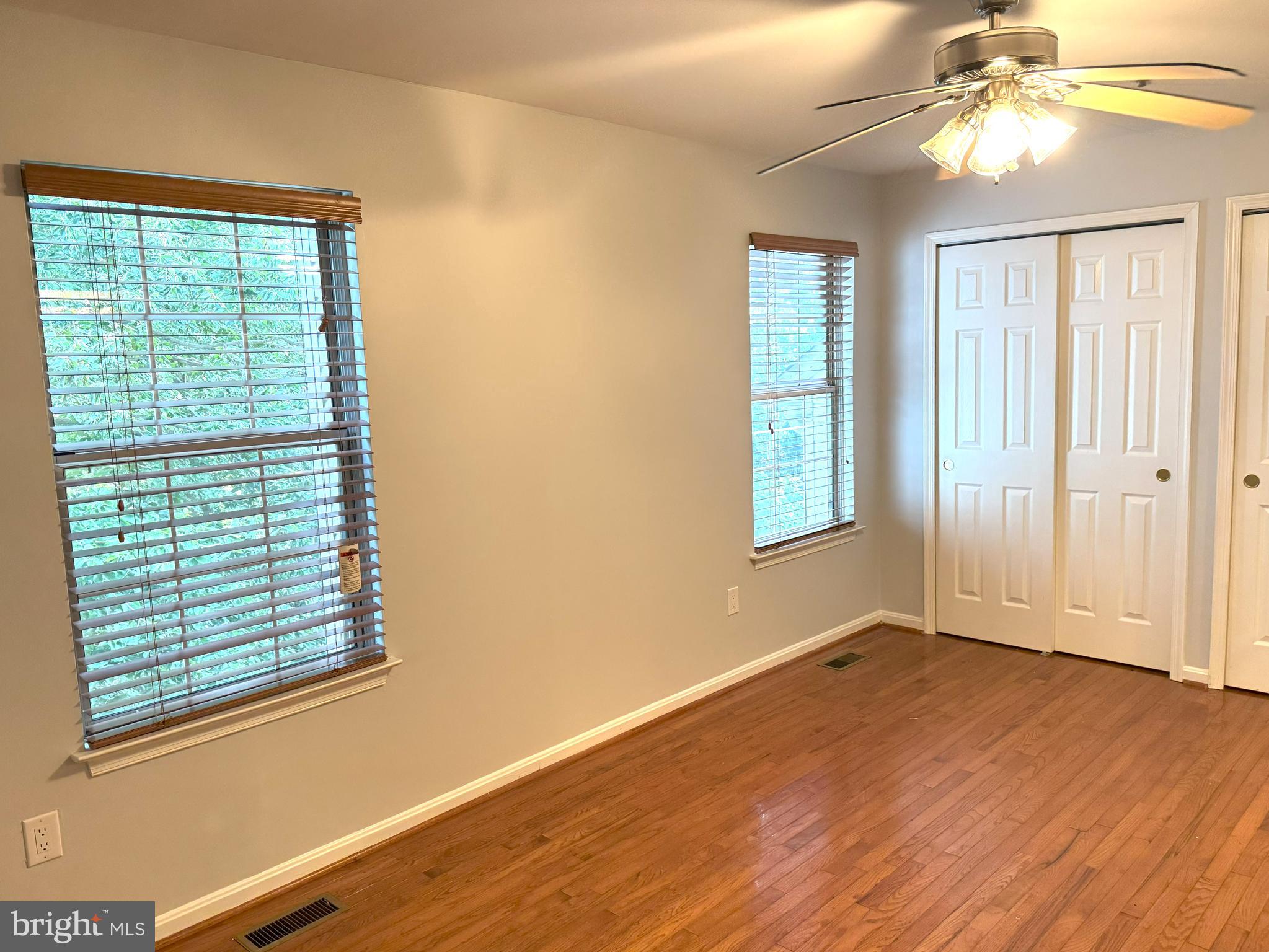 618 Evening Star Place Bowie, MD 20721 - Photo 34 of 59 a view of an empty room with wooden floor and a window