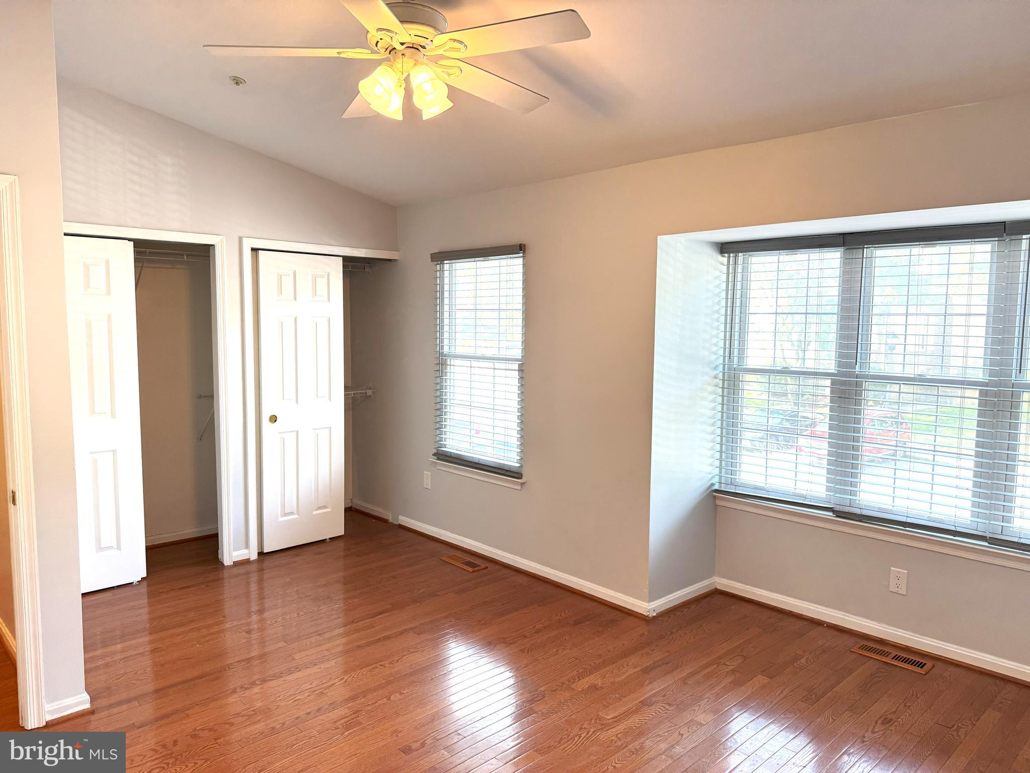 618 Evening Star Place Bowie, MD 20721 - Photo 4 of 59 a view of an empty room with wooden floor and a window
