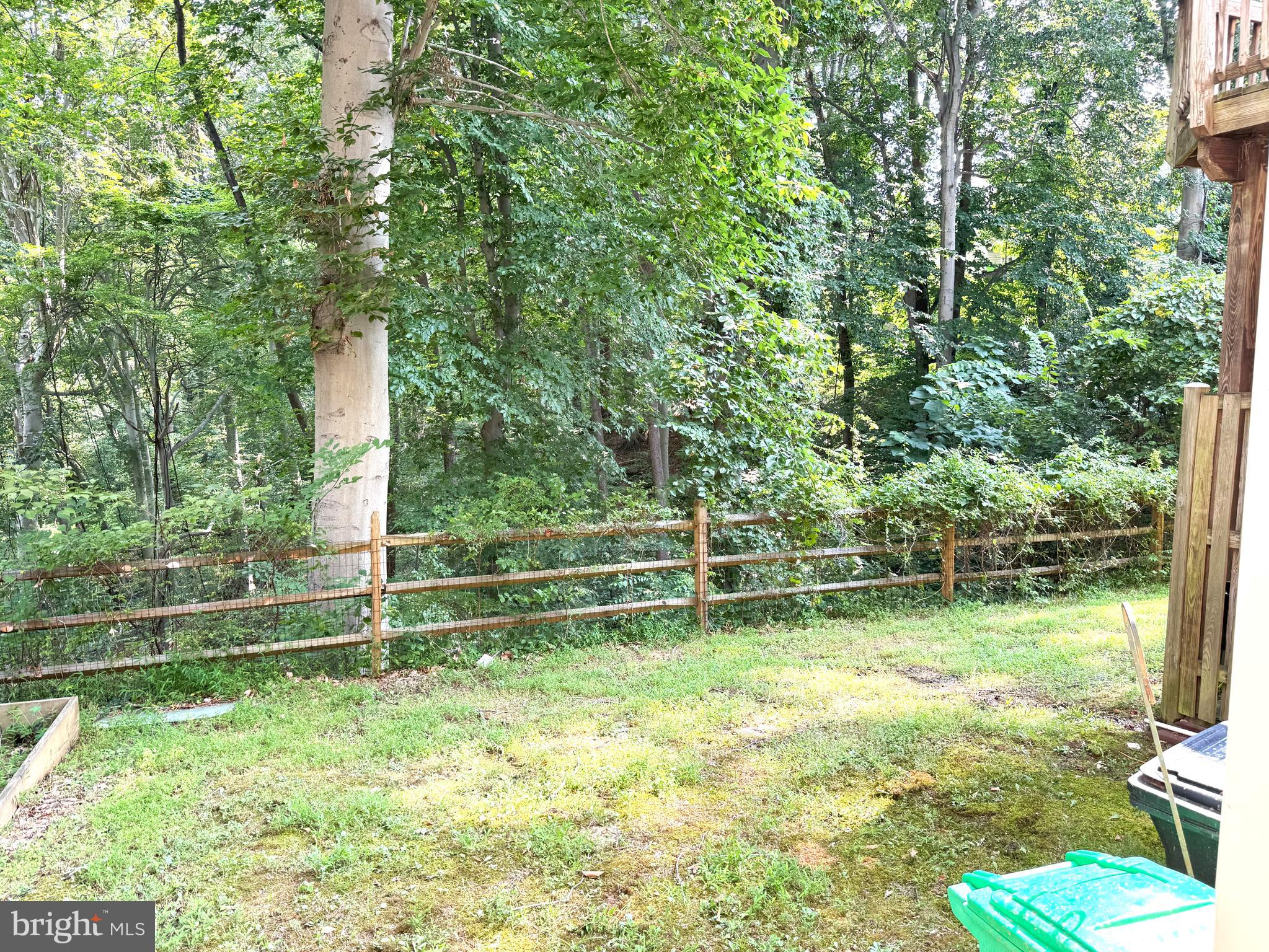 618 Evening Star Place Bowie, MD 20721 - Photo 51 of 59 a backyard of a house with lots of green space and plants