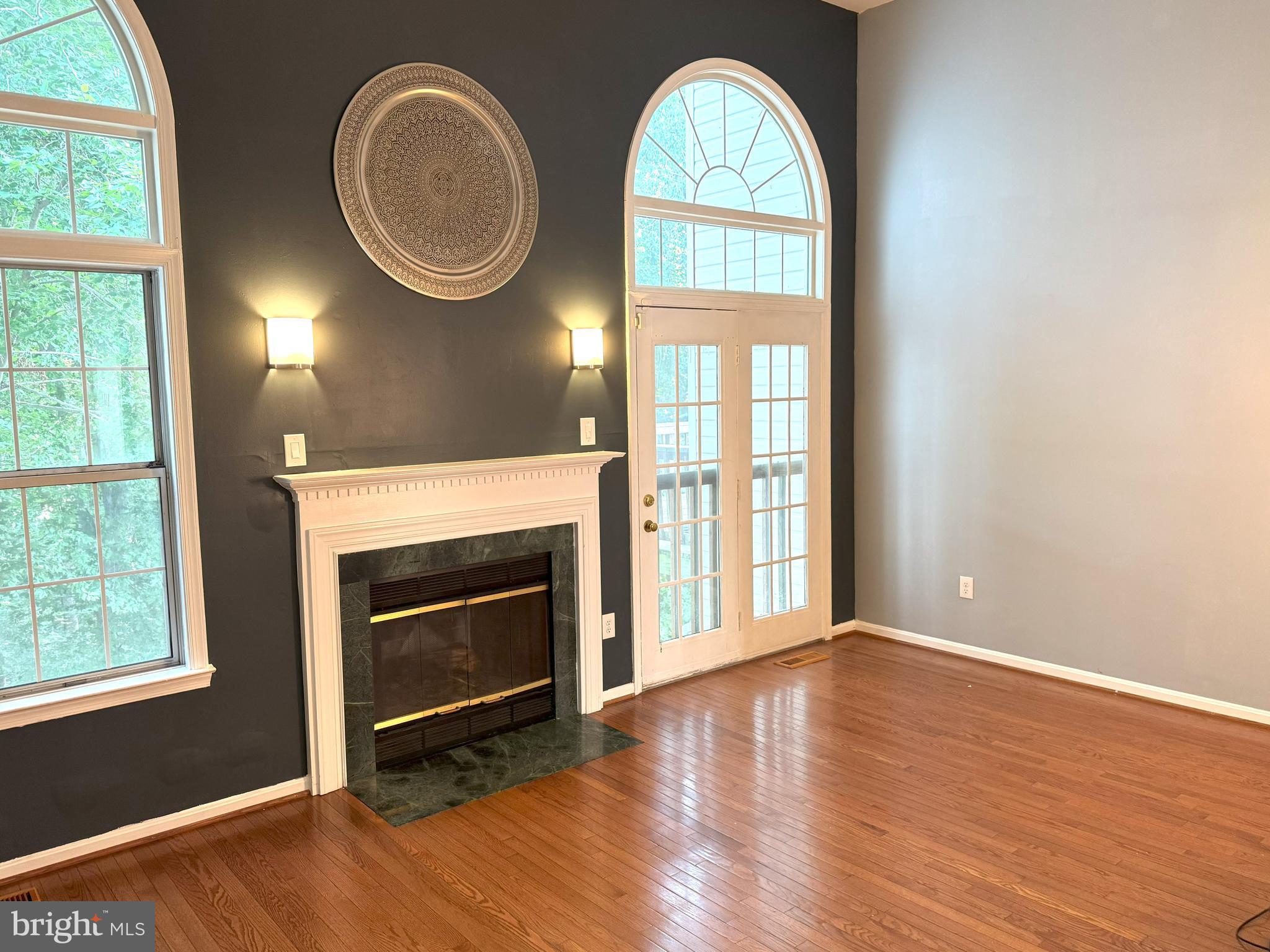 618 Evening Star Place Bowie, MD 20721 - Photo 58 of 59 an empty room with wooden floor windows and fireplace