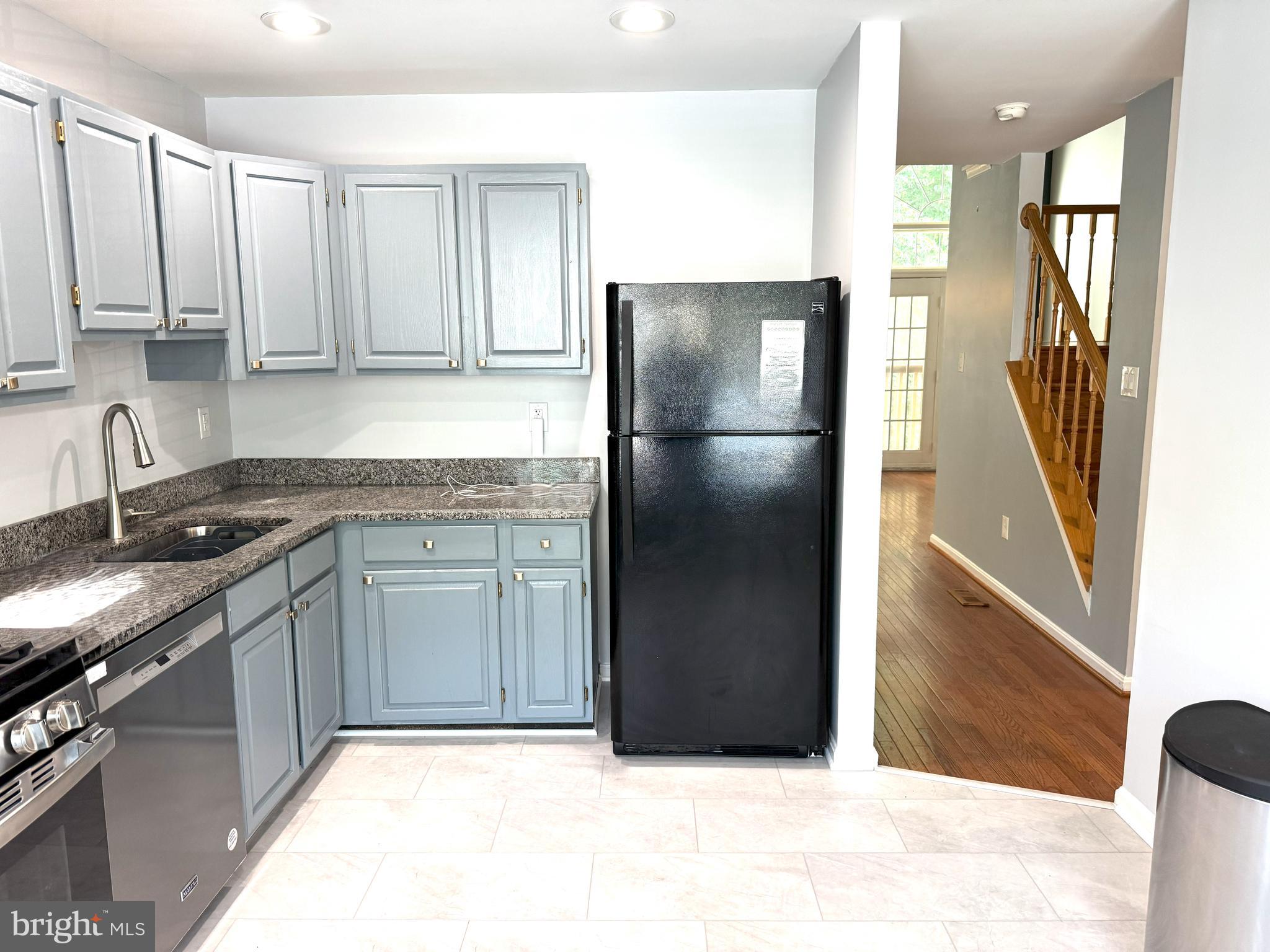 618 Evening Star Place Bowie, MD 20721 - Photo 7 of 59 a kitchen with a refrigerator sink and cabinets