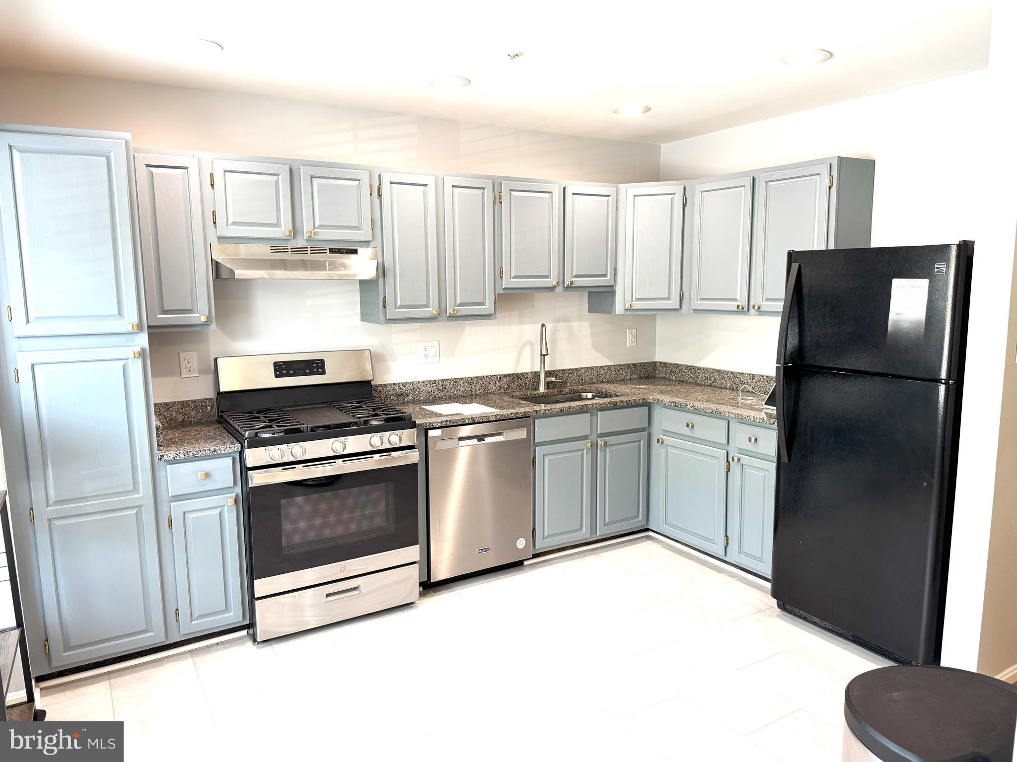 618 Evening Star Place Bowie, MD 20721 - Photo 10 of 59 a kitchen with a white cabinets and refrigerator