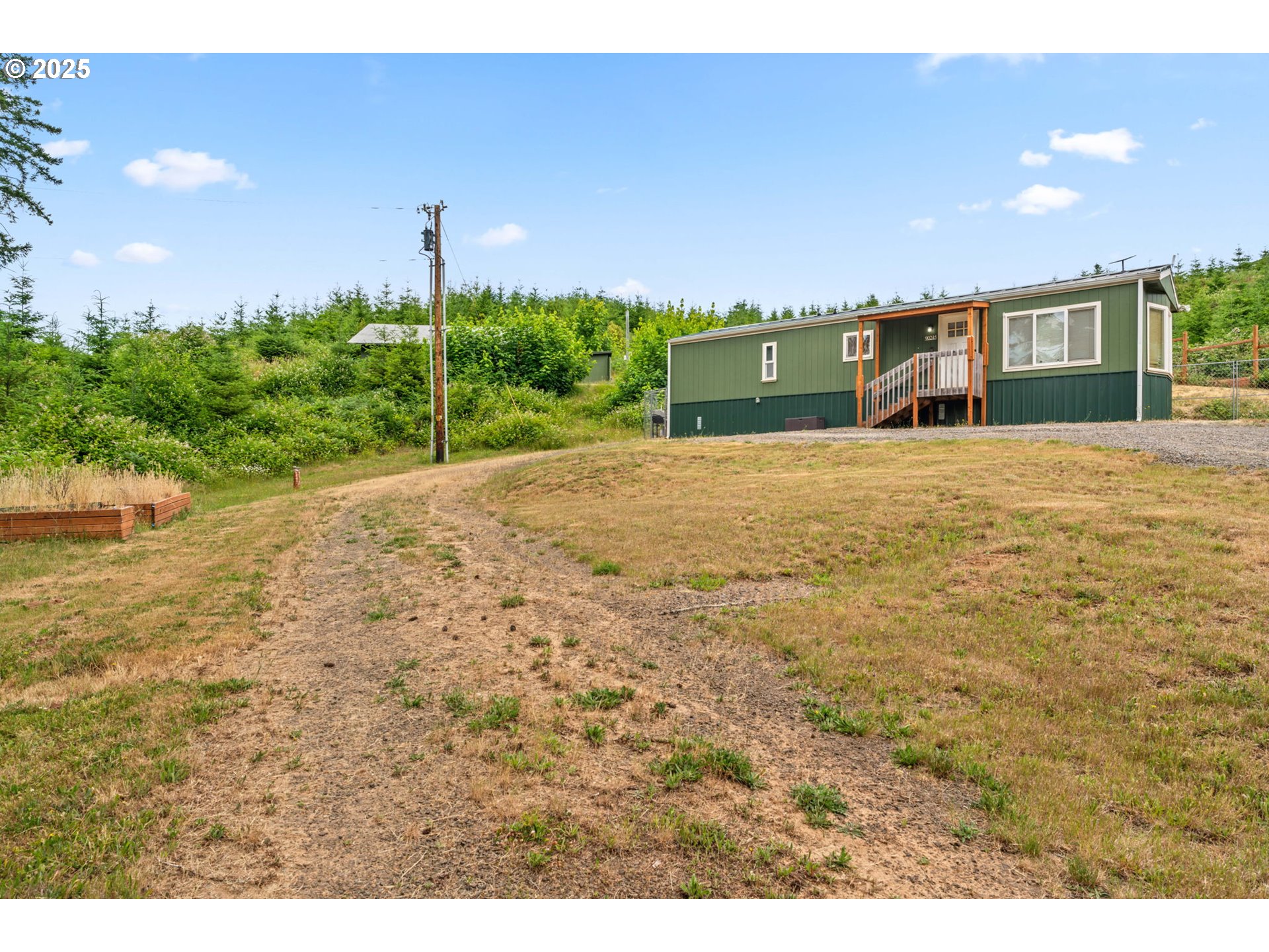 90245 Sheffler Road Elmira, OR 97437 - Photo 18 of 33 a front view of a house with a yard and a garage