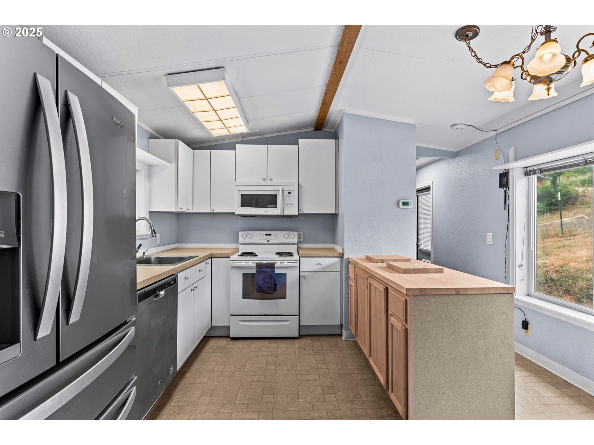 90245 Sheffler Road Elmira, OR 97437 - Photo 5 of 33 a kitchen with kitchen island granite countertop a sink stainless steel appliances and cabinets