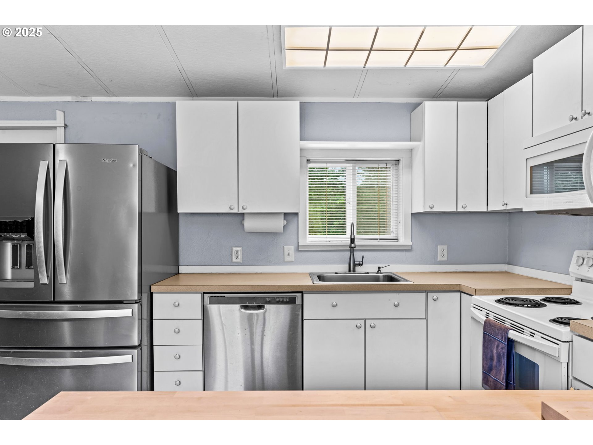 90245 Sheffler Road Elmira, OR 97437 - Photo 7 of 33 a kitchen with a sink a stove a refrigerator and cabinets