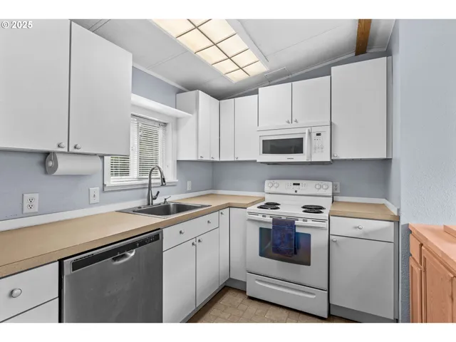 a kitchen with a sink stove and microwave