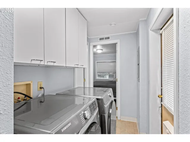 a kitchen with a sink cabinets and appliances