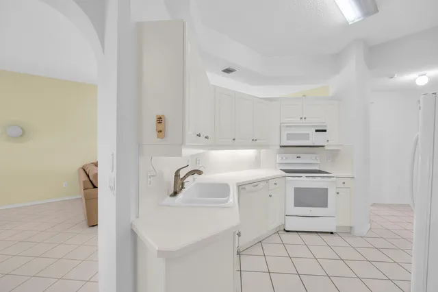 a kitchen with a sink cabinets and appliances