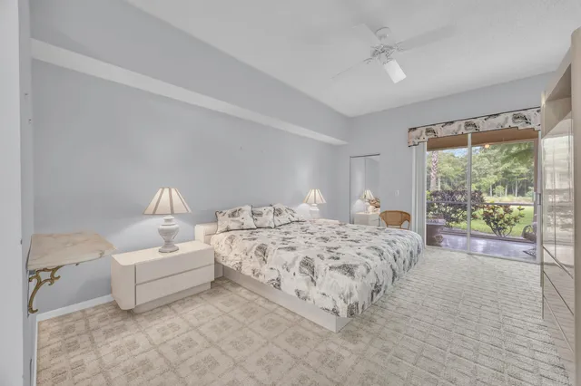 a spacious bedroom with a bed and a large window