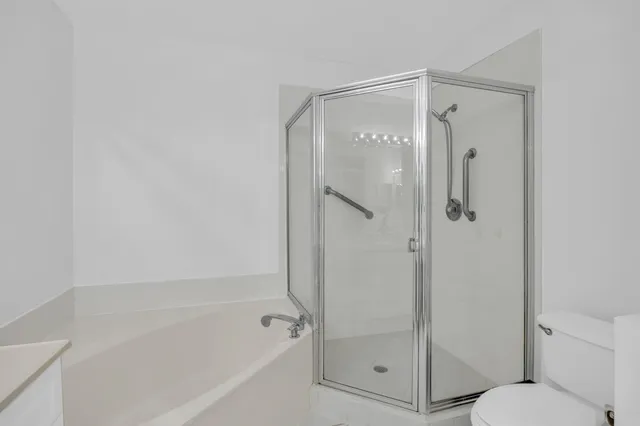 a bathroom with a glass shower door