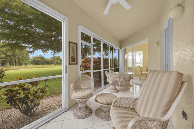 a living room with furniture and a floor to ceiling window