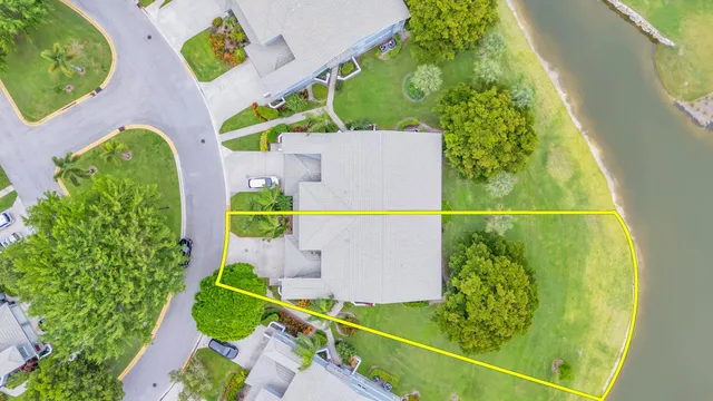 an aerial view of residential building and lake