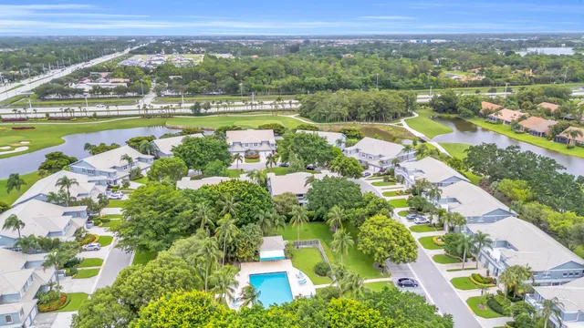 an aerial view of residential houses with outdoor space and trees