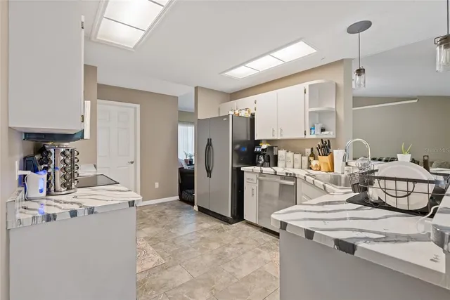 a kitchen with a sink appliances and cabinets