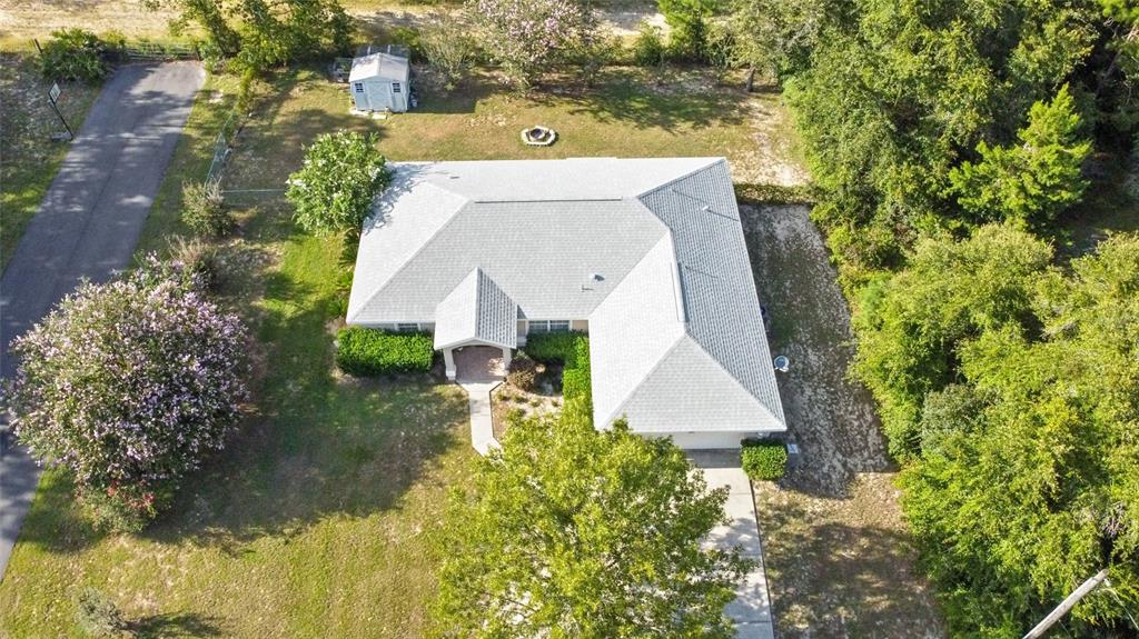 5065 Southwest 128th Street Ocala, FL 34473 - Photo 20 of 31 an aerial view of a house with swimming pool and garden