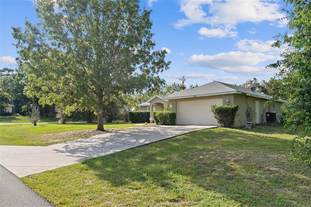5065 Southwest 128th Street Ocala, FL 34473 - Photo 2 of 31 a house view with a garden space