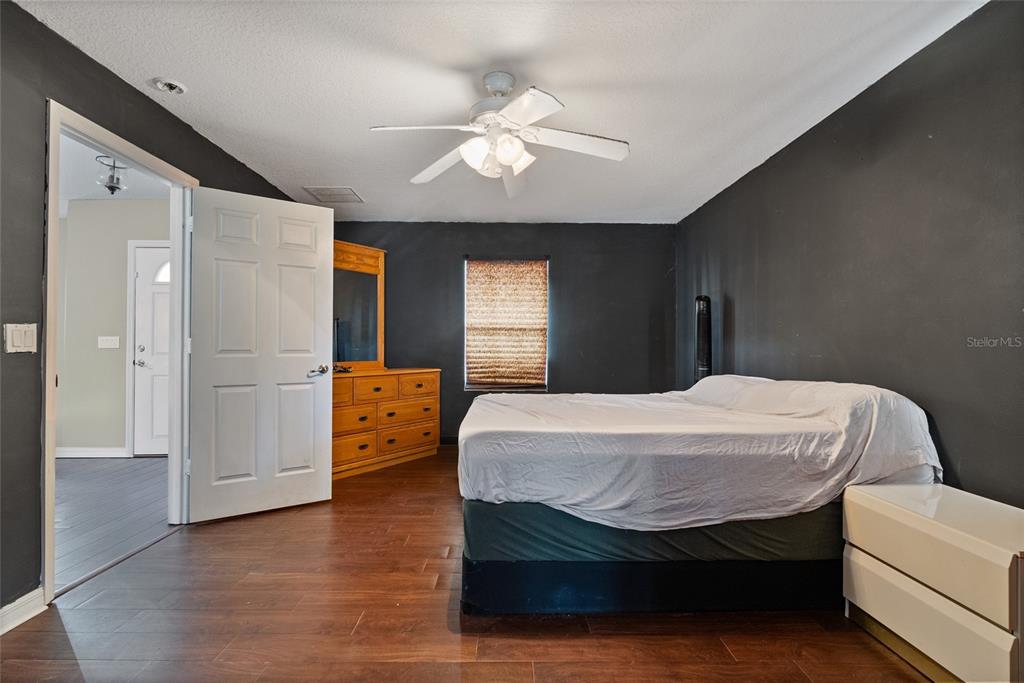 5065 Southwest 128th Street Ocala, FL 34473 - Photo 24 of 31 a bedroom with a bed and a chandelier