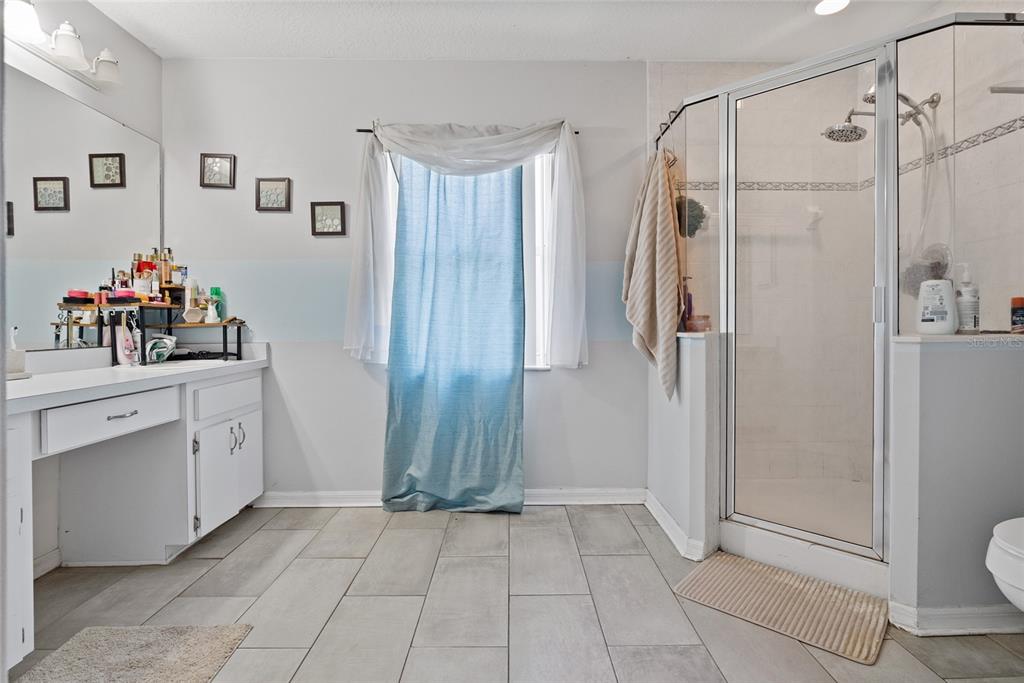 5065 Southwest 128th Street Ocala, FL 34473 - Photo 25 of 31 a bathroom with a shower sink and toilet