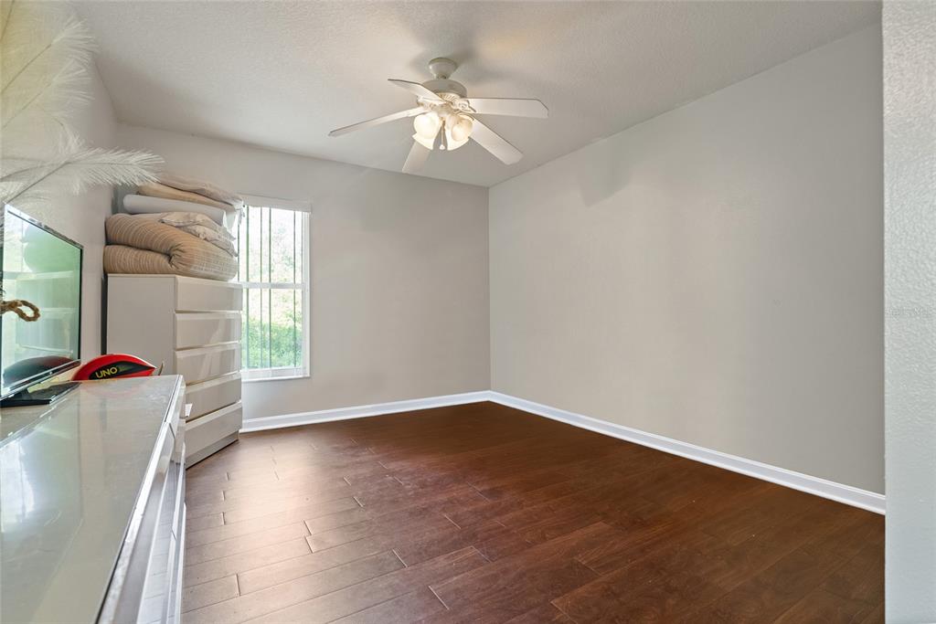 5065 Southwest 128th Street Ocala, FL 34473 - Photo 29 of 31 an empty room with wooden floor and windows