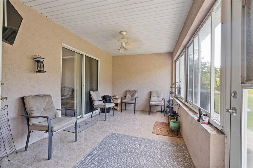 5065 Southwest 128th Street Ocala, FL 34473 - Photo 30 of 31 a living room with furniture and a chandelier
