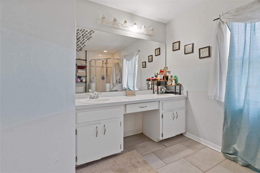 5065 Southwest 128th Street Ocala, FL 34473 - Photo 8 of 31 a spacious bathroom with a double vanity sink mirror and