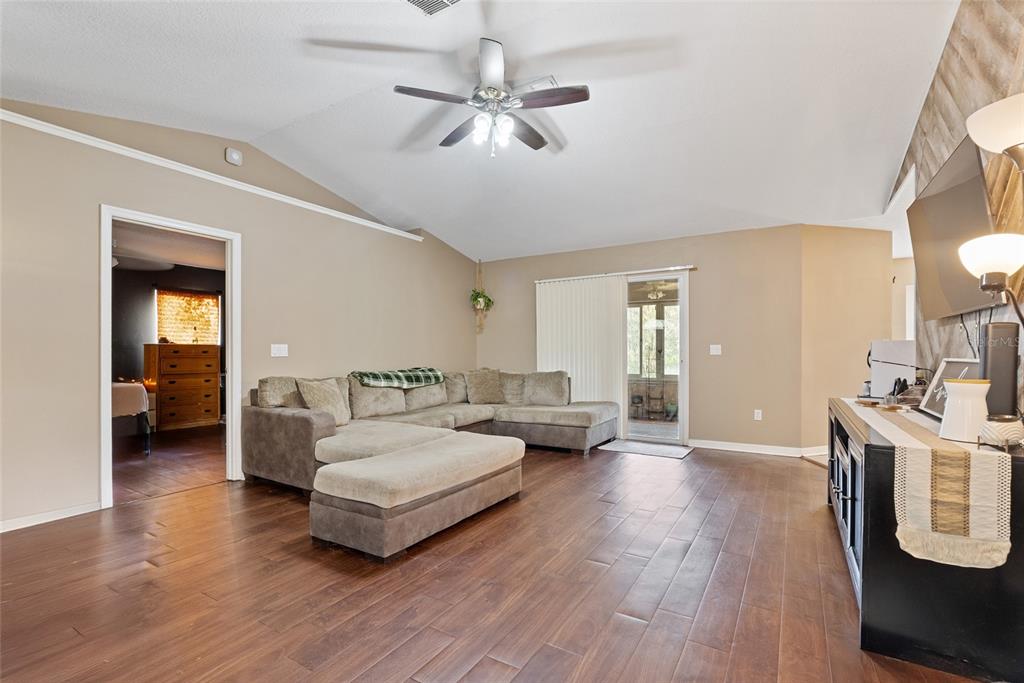 5065 Southwest 128th Street Ocala, FL 34473 - Photo 10 of 31 a living room with furniture and a wooden floor