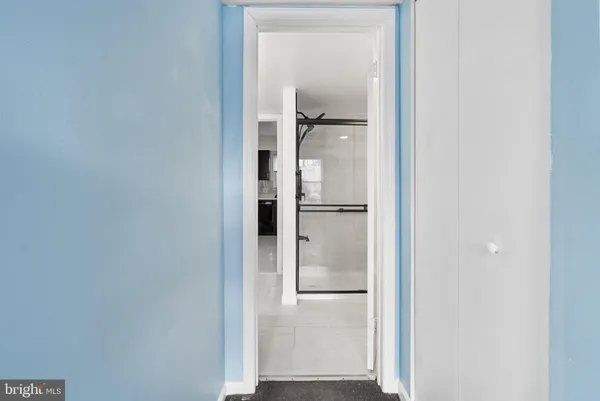 a view of hallway with wooden floor