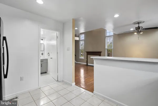 a view of a kitchen with a refrigerator and a sink