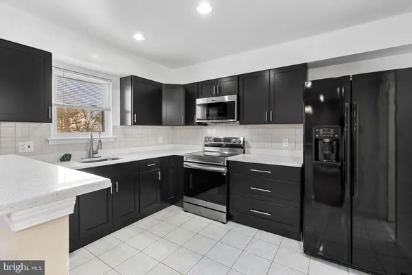 a kitchen with a sink stove and refrigerator