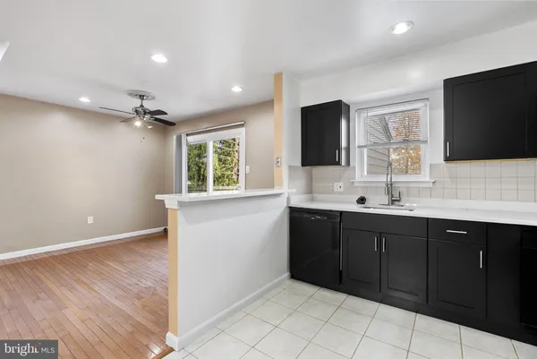 a bathroom with a double vanity sink a mirror and a bathtub