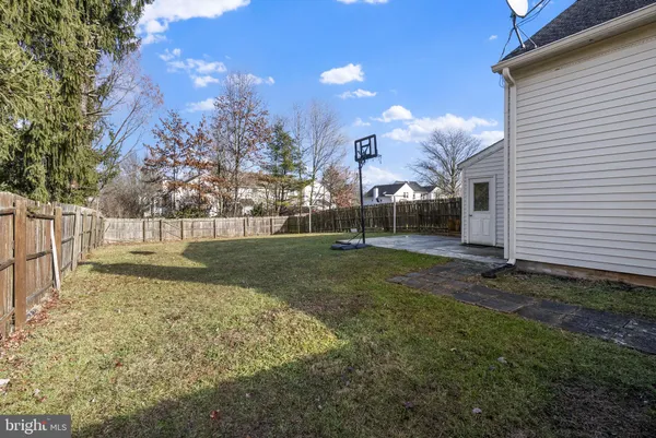 a view of a house with backyard and a tree