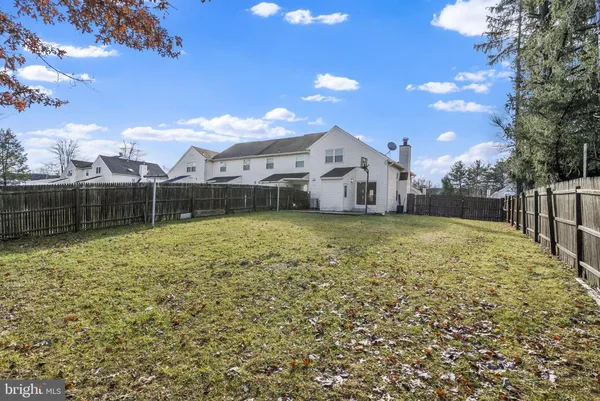 a view of a yard with a house in the background